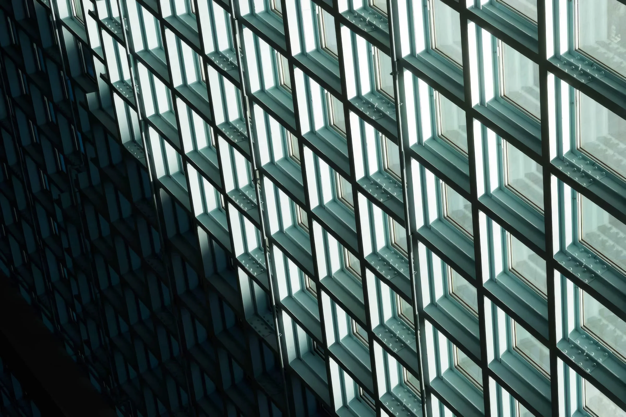 A glass facade in a grid of square panes.