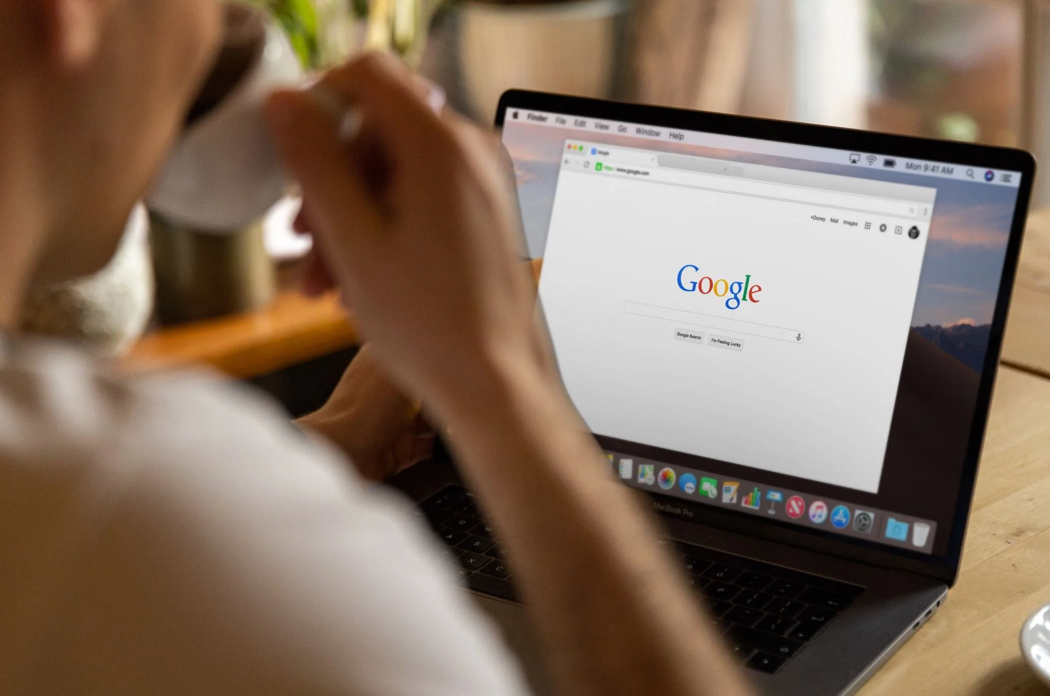 A person at a laptop with Google search open.
